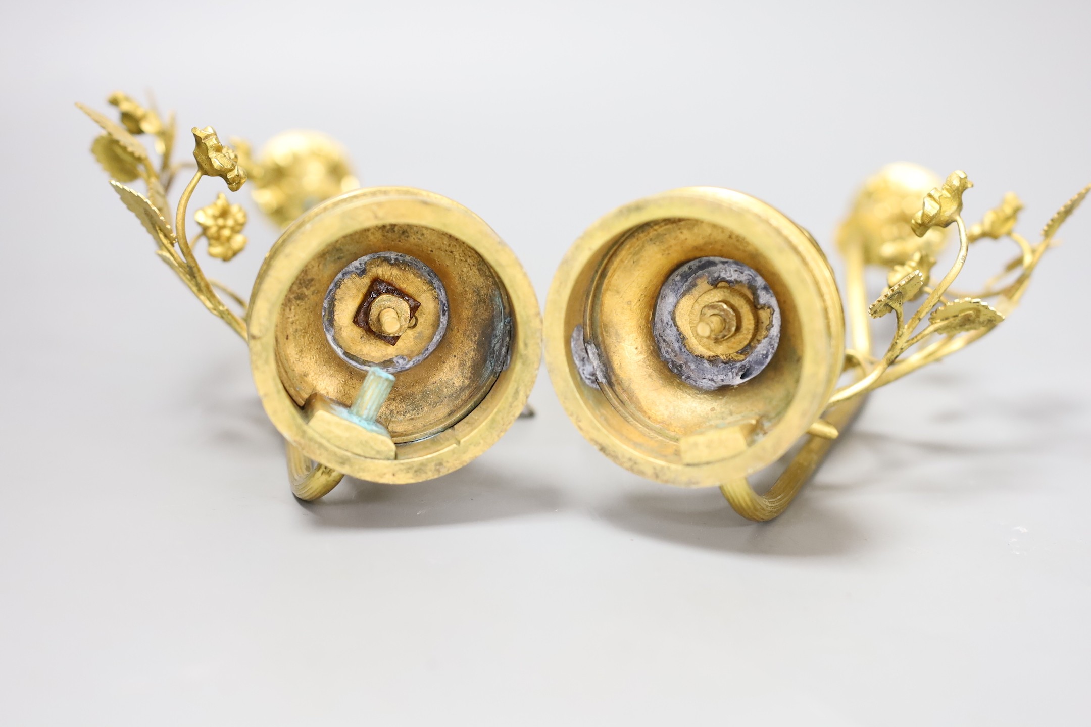A pair of figural gilt metal candlesticks (Birmingham 1902 by Elkington & Company and Chester 1922(?) by Haseler Brothers, 28cm